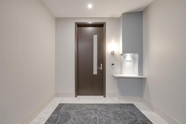 2600 W 7th St Unit 2452, Fort Worth, TX 76107 - entrance foyer featuring elevator, light marble finish floors, and recessed lighting