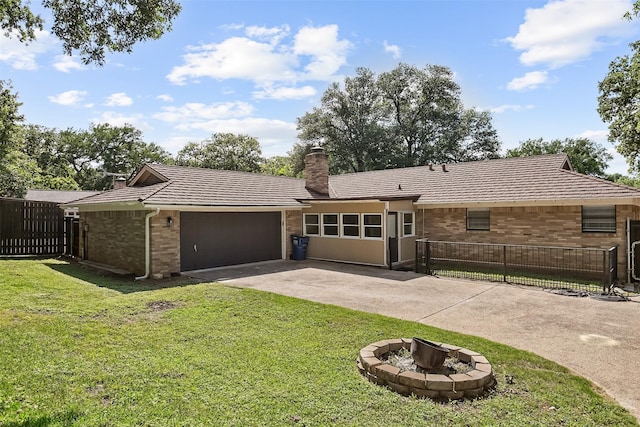 212 Timberlake Dr, Azle, TX 76020 - rear view of house with brick siding, a garage, concrete driveway, a chimney, and an outdoor fire pit