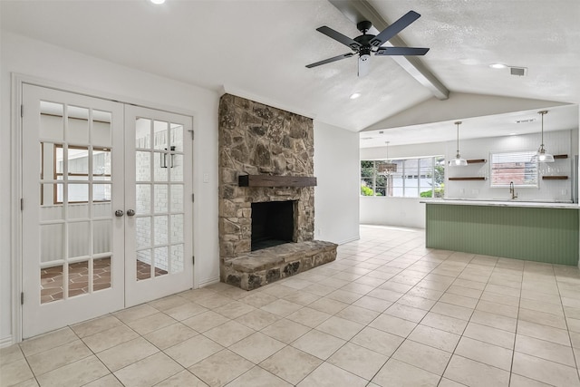 212 Timberlake Dr, Azle, TX 76020 - unfurnished living room featuring french doors, ceiling fan, light tile patterned floors, recessed lighting, and a stone fireplace