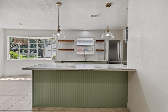 212 Timberlake Dr, Azle, TX 76020 - kitchen with freestanding refrigerator, open shelves, a breakfast bar area, hanging light fixtures, and a textured ceiling