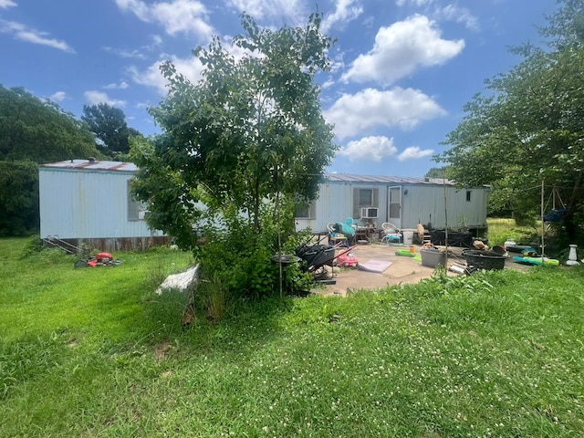 740 Ash St, Blossom, TX 75416 - rear view of house featuring a lawn and a patio area
