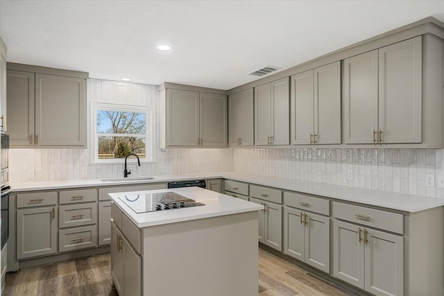 110 Vz County Road 1128, Fruitvale, TX 75127 - kitchen with gray cabinetry, black electric cooktop, decorative backsplash, dark wood-style flooring, and recessed lighting