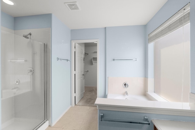 108 Bear Trl, Waxahachie, TX 75165 - full bath with a stall shower, a spacious closet, vanity, and tile patterned floors