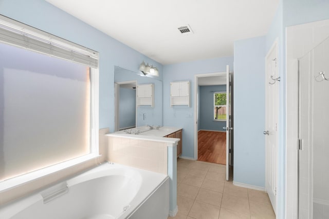 108 Bear Trl, Waxahachie, TX 75165 - full bathroom with a garden tub, vanity, and tile patterned flooring