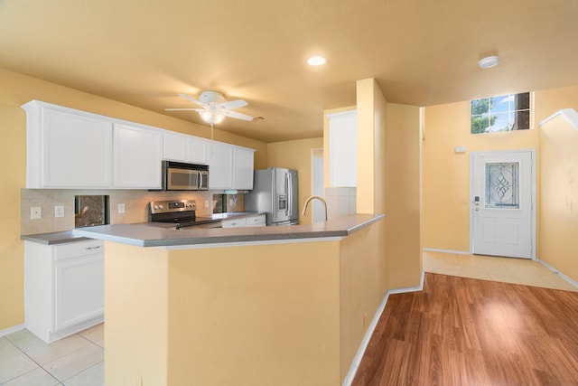 108 Bear Trl, Waxahachie, TX 75165 - kitchen with appliances with stainless steel finishes, white cabinetry, decorative backsplash, ceiling fan, and recessed lighting
