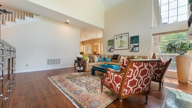 2741 Barrington Dr, Plano, TX 75093 - living room featuring high vaulted ceiling, dark wood finished floors, stairway, and ornamental molding