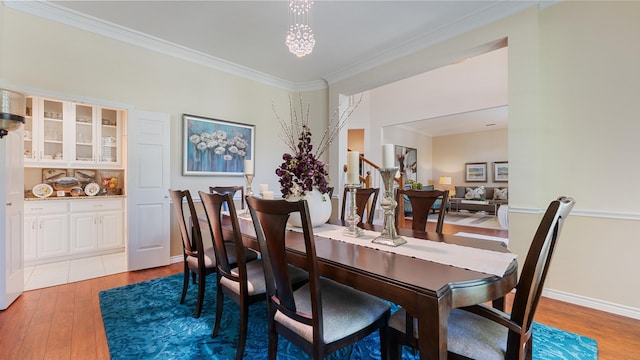 2741 Barrington Dr, Plano, TX 75093 - dining space with light wood finished floors, ornamental molding, and a chandelier