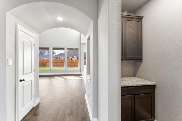 1800 Trotter Trl, Aubrey, TX 76227 - hallway featuring dark wood-type flooring and arched walkways