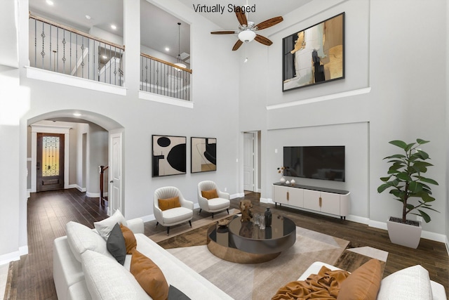 1800 Trotter Trl, Aubrey, TX 76227 - living area with arched walkways, a ceiling fan, wood finished floors, a towering ceiling, and recessed lighting