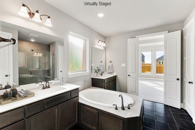 1800 Trotter Trl, Aubrey, TX 76227 - bathroom with a garden tub, a stall shower, two vanities, and recessed lighting