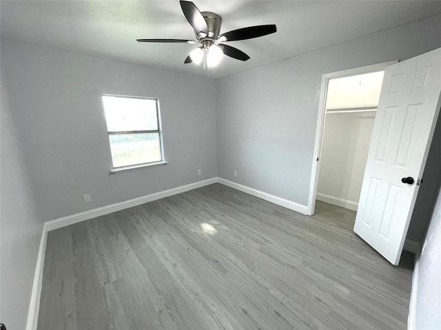 5146 Fm 879, Palmer, TX 75152 - unfurnished bedroom featuring light wood finished floors, ceiling fan, a closet, and a spacious closet