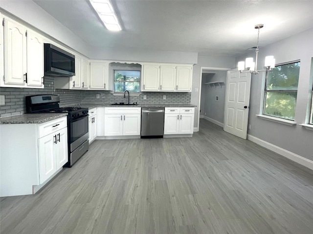 5146 Fm 879, Palmer, TX 75152 - kitchen featuring appliances with stainless steel finishes, tasteful backsplash, white cabinets, and a chandelier