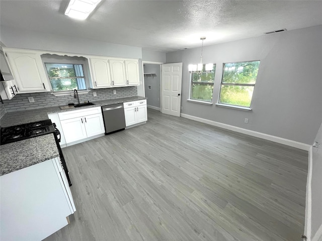 5146 Fm 879, Palmer, TX 75152 - kitchen with stainless steel dishwasher, decorative backsplash, white cabinetry, light wood-style floors, and range with gas cooktop