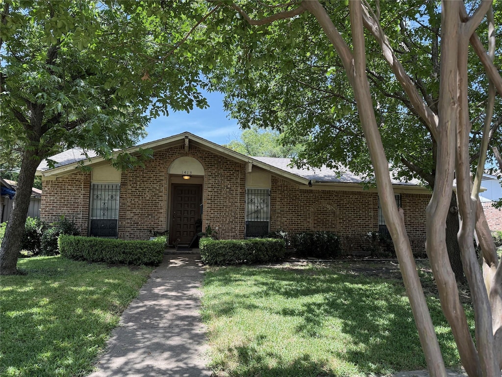 1413 Park E Dr, Garland, TX 75043 - view of front of home with brick siding and a front lawn