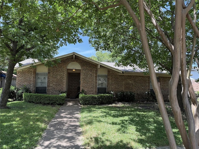 1413 Park E Dr, Garland, TX 75043 - view of front of home with brick siding and a front lawn