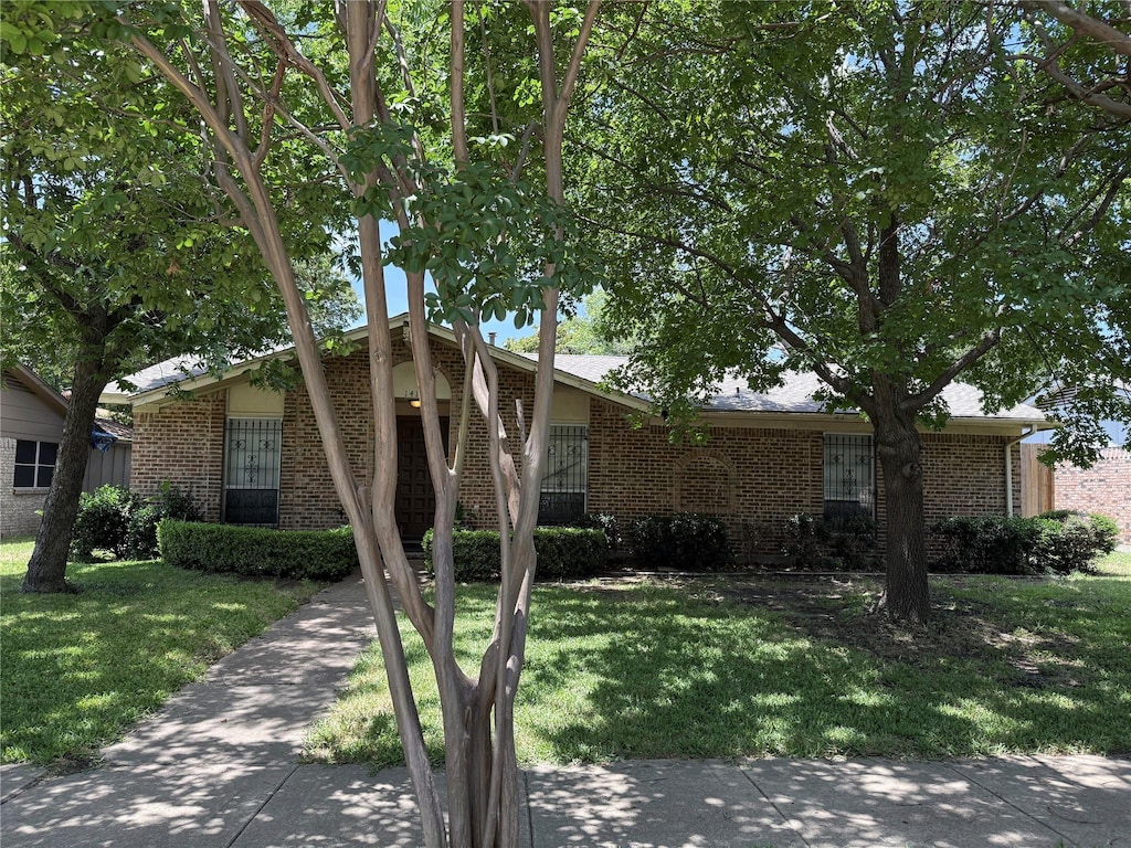 1413 Park E Dr, Garland, TX 75043 - view of front facade with brick siding and a front yard