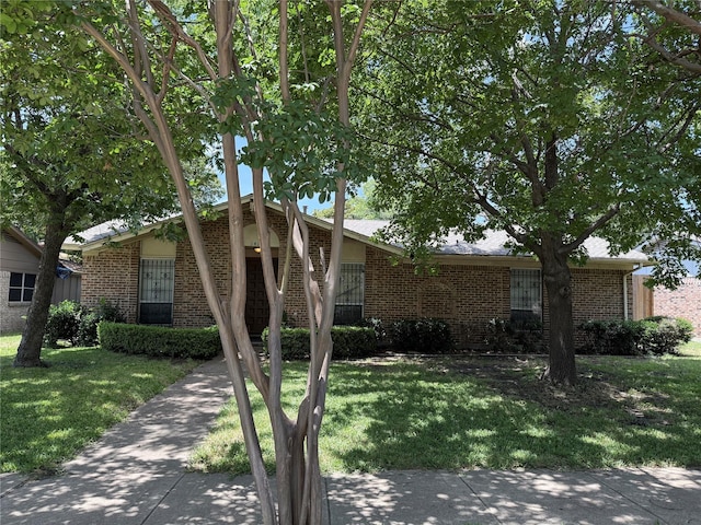 1413 Park E Dr, Garland, TX 75043 - view of front facade with brick siding and a front yard