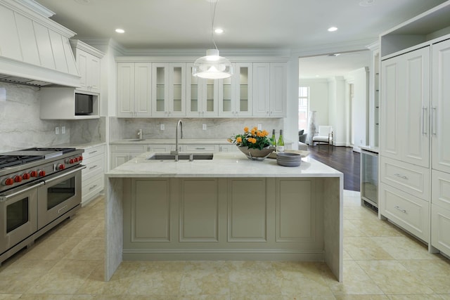 2555 N Pearl St Unit 1101, Dallas, TX 75201 - kitchen featuring double oven range, custom range hood, an island with sink, tasteful backsplash, and white cabinetry