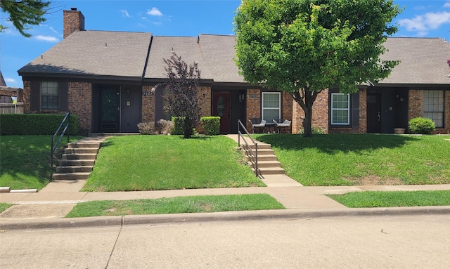 5021 Buttonwood Ln, Garland, TX 75043 - view of front facade with a front yard, a chimney, and brick siding