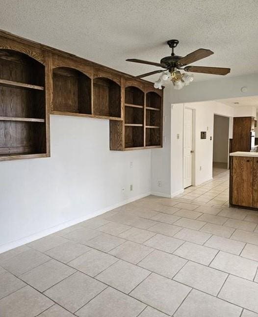 1601 Meadow Ln, Terrace, Fort Worth, TX 76112 - empty room with a ceiling fan, a textured ceiling, and light tile patterned flooring