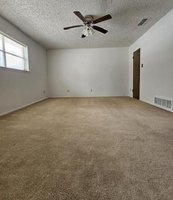 1601 Meadow Ln, Terrace, Fort Worth, TX 76112 - carpeted empty room featuring ceiling fan and a textured ceiling