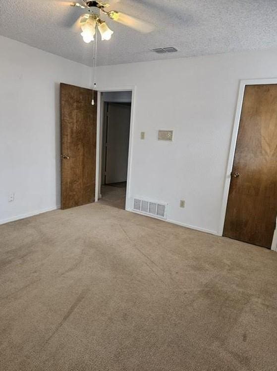 1601 Meadow Ln, Terrace, Fort Worth, TX 76112 - carpeted spare room featuring a textured ceiling and ceiling fan