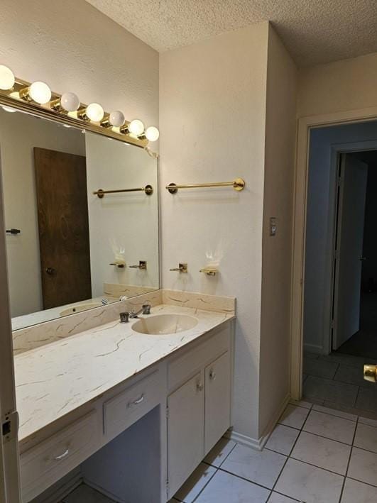 1601 Meadow Ln, Terrace, Fort Worth, TX 76112 - bathroom with a textured ceiling, vanity, and tile patterned flooring