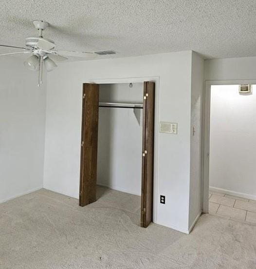 1601 Meadow Ln, Terrace, Fort Worth, TX 76112 - unfurnished bedroom with carpet floors, a closet, a ceiling fan, and a textured ceiling