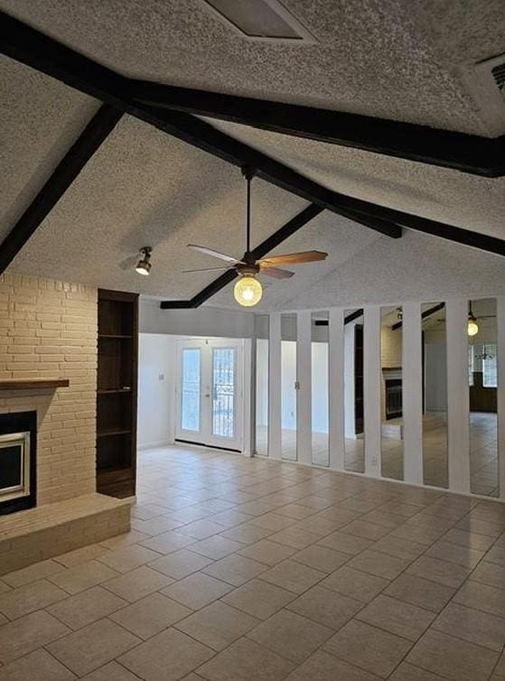 1601 Meadow Ln, Terrace, Fort Worth, TX 76112 - unfurnished living room featuring a textured ceiling, tile patterned flooring, a brick fireplace, french doors, and ceiling fan