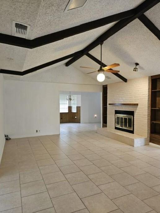 1601 Meadow Ln, Terrace, Fort Worth, TX 76112 - unfurnished living room with a brick fireplace, ceiling fan, a textured ceiling, and light tile patterned floors