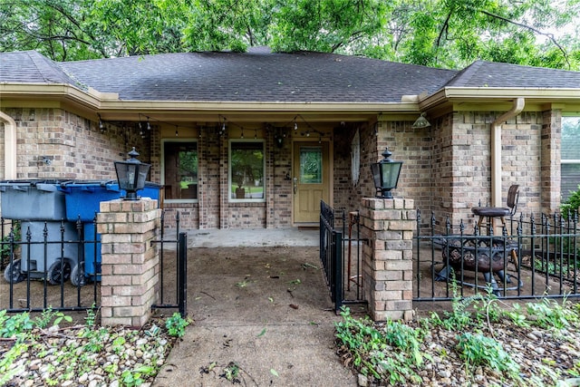 1237 Linkwood Ln, Lancaster, TX 75146 - doorway to property with a shingled roof, brick siding, and covered porch