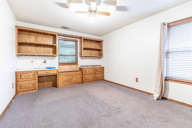 1237 Linkwood Ln, Lancaster, TX 75146 - unfurnished office with ceiling fan, light colored carpet, built in study area, and a textured ceiling