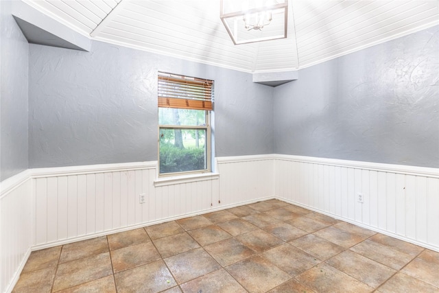 1237 Linkwood Ln, Lancaster, TX 75146 - unfurnished room featuring a wainscoted wall, a chandelier, and stone finish floors