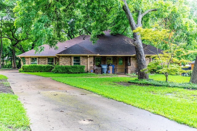 1237 Linkwood Ln, Lancaster, TX 75146 - view of front of home with a front lawn, a shingled roof, a porch, and brick siding