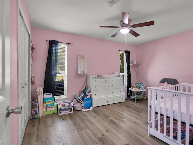 6708 Wagonet Rd, Forest Hill, TX 76140 - bedroom featuring wood finished floors, a crib, and a ceiling fan