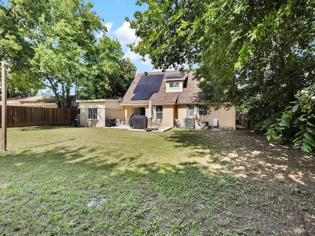 6708 Wagonet Rd, Forest Hill, TX 76140 - back of house featuring roof mounted solar panels, a fenced backyard, a patio, and brick siding