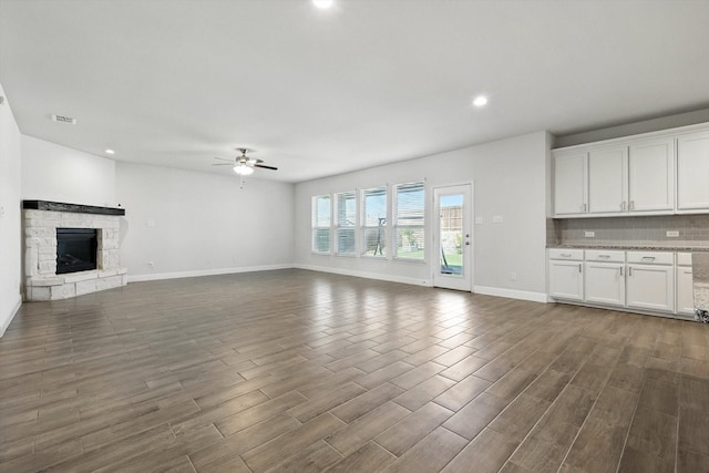 260 Clairmont Dr, Ponder, TX 76259 - unfurnished living room with a ceiling fan, dark wood-style flooring, a stone fireplace, and recessed lighting