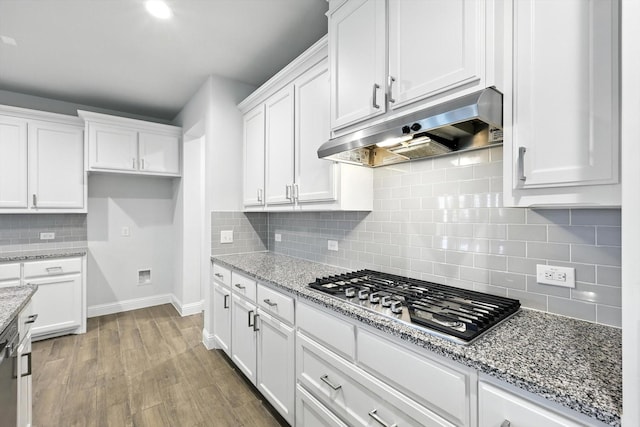260 Clairmont Dr, Ponder, TX 76259 - kitchen featuring under cabinet range hood, stainless steel gas cooktop, white cabinets, decorative backsplash, and wood finished floors