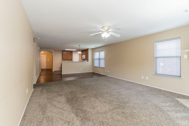 13264 Harvest Ridge Rd, Fort Worth, TX 76244 - unfurnished living room featuring dark carpet, arched walkways, and a ceiling fan