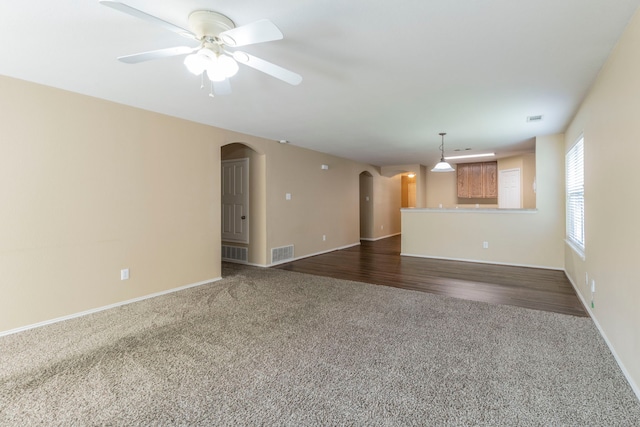 13264 Harvest Ridge Rd, Fort Worth, TX 76244 - unfurnished living room featuring arched walkways, dark colored carpet, and ceiling fan