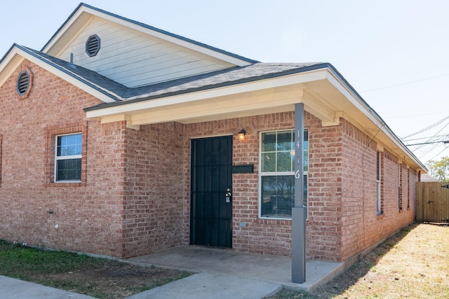 1416 E Mulkey St, Fort Worth, TX 76104 - view of front facade featuring brick siding and roof with shingles