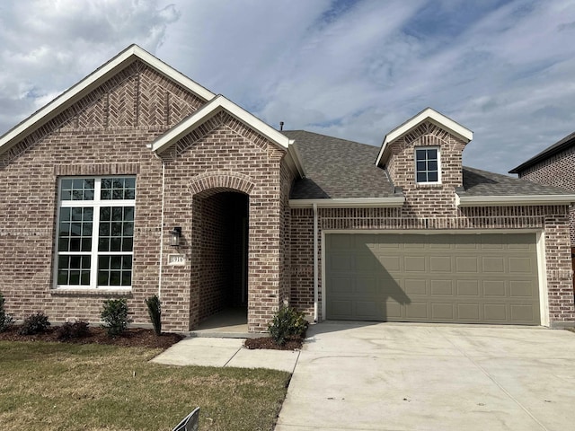 1916 Honey Creek Rd, Forney, TX 75126 - view of front of house with brick siding, a garage, a shingled roof, concrete driveway, and a front lawn