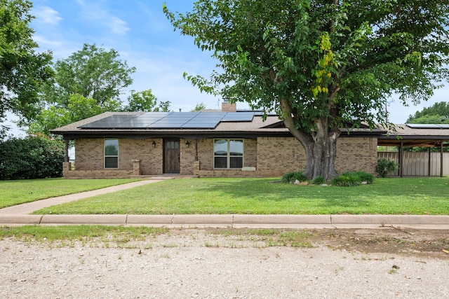 2200 SE 26th Ave, Mineral Wells, TX 76067 - view of front of property featuring roof mounted solar panels, brick siding, and a chimney