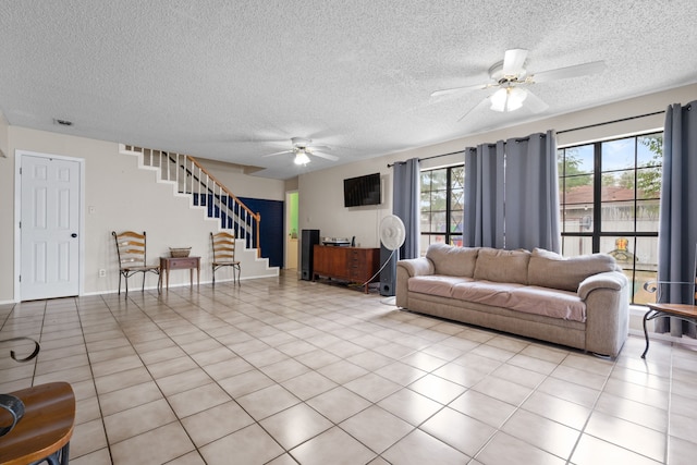 2200 SE 26th Ave, Mineral Wells, TX 76067 - living room with ceiling fan, stairway, a textured ceiling, and light tile patterned floors