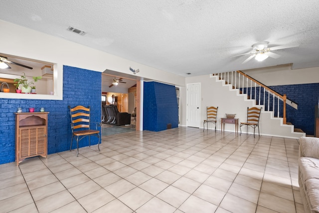 2200 SE 26th Ave, Mineral Wells, TX 76067 - living room featuring ceiling fan, stairs, and a textured ceiling