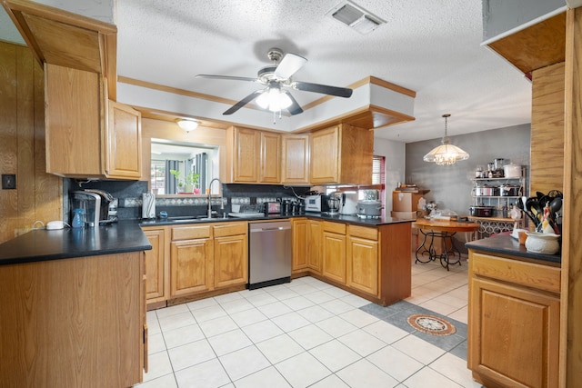 2200 SE 26th Ave, Mineral Wells, TX 76067 - kitchen featuring stainless steel dishwasher, dark countertops, plenty of natural light, and a textured ceiling