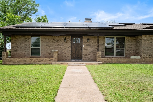 2200 SE 26th Ave, Mineral Wells, TX 76067 - view of front of house featuring a front yard, brick siding, and solar panels
