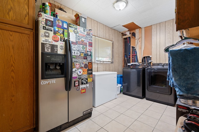 2200 SE 26th Ave, Mineral Wells, TX 76067 - laundry room with washer and dryer, light tile patterned floors, and wooden walls