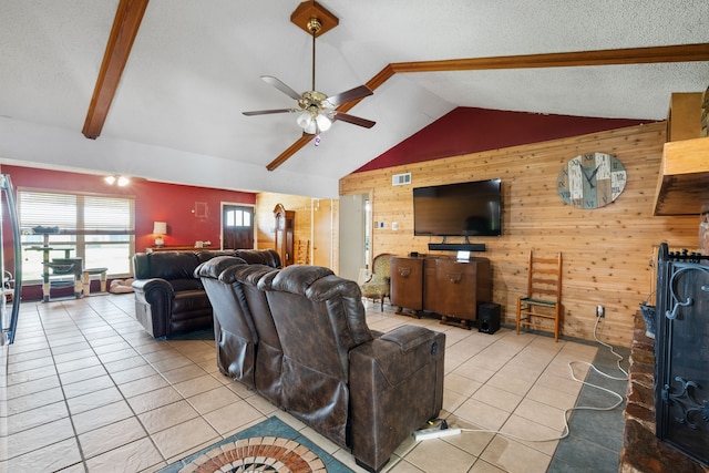 2200 SE 26th Ave, Mineral Wells, TX 76067 - tiled living room featuring wooden walls, a ceiling fan, and a textured ceiling
