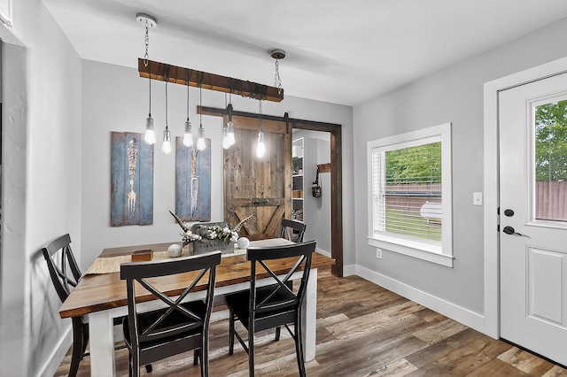 1008 County Road 4759, Sulphur Springs, TX 75482 - dining space featuring wood finished floors and a barn door
